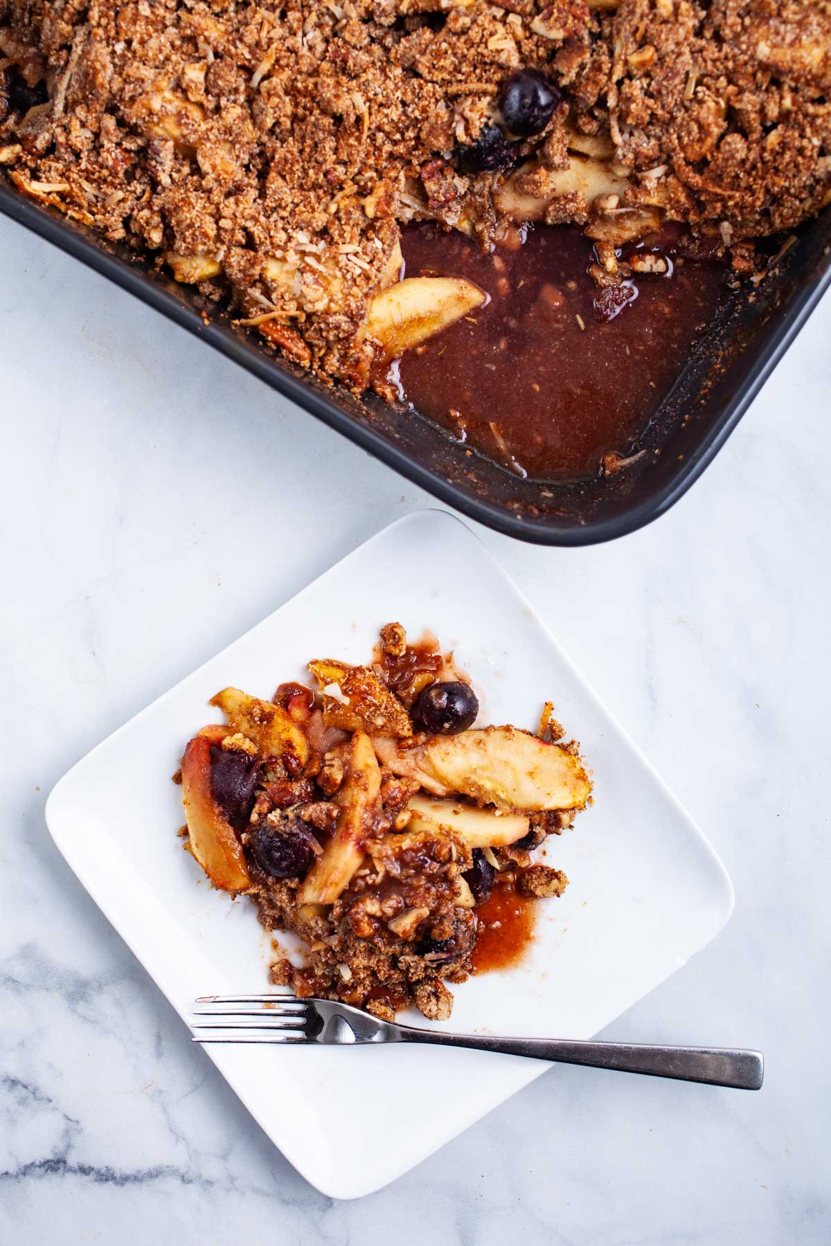 Healthy Paleo apple crumble with cherries served on a plate.