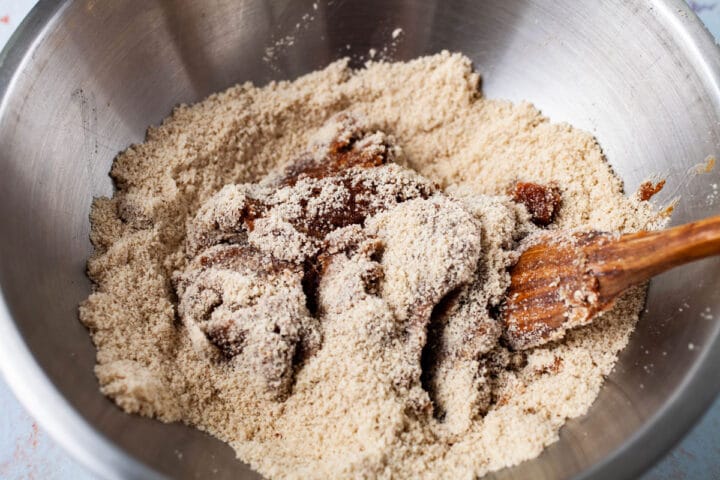 Almond flour being mixed in with wet ingredients.
