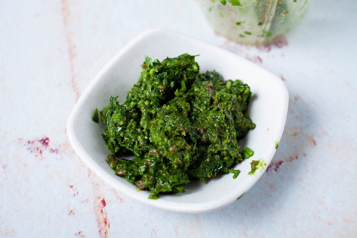 A green parsley paste in a small bowl.