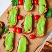 Anchovy starters served on a wooden board.