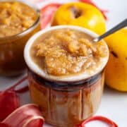 Apple rhubarb compote served in a small honey jar.