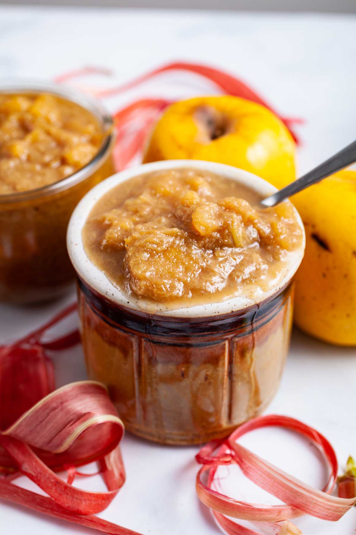 Apple rhubarb compote served in a small honey jar.