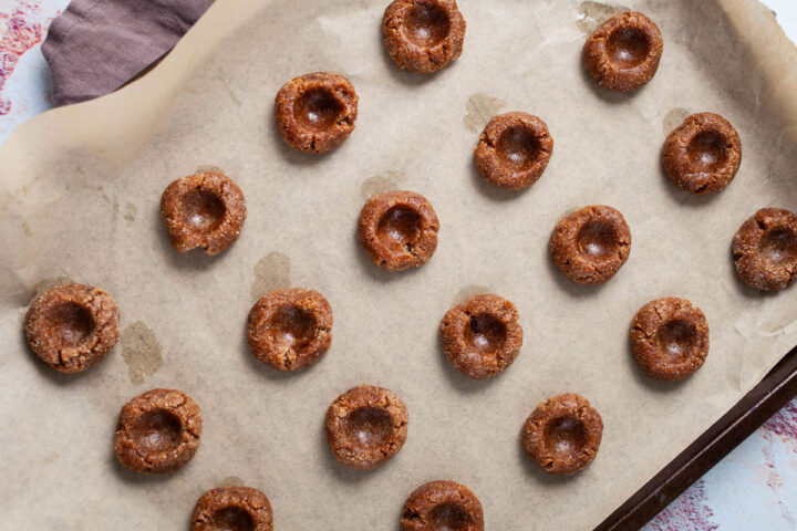 unbaked cookies on a prepared baking sheet.