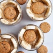 Cups of creamy Paleo banana pudding garnished with cookies.