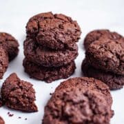 Chocolate almond flour cookies stacked on top of each other.
