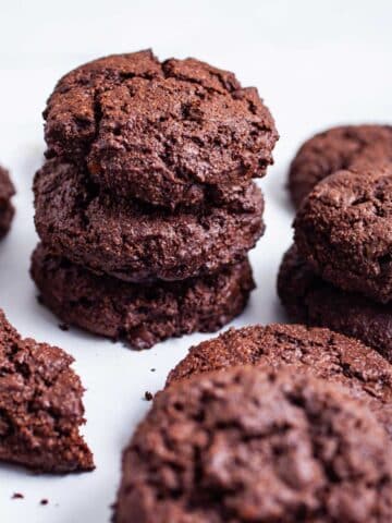 Chocolate almond flour cookies stacked on top of each other.