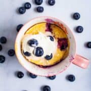 An almond flour mug cake with blueberries.
