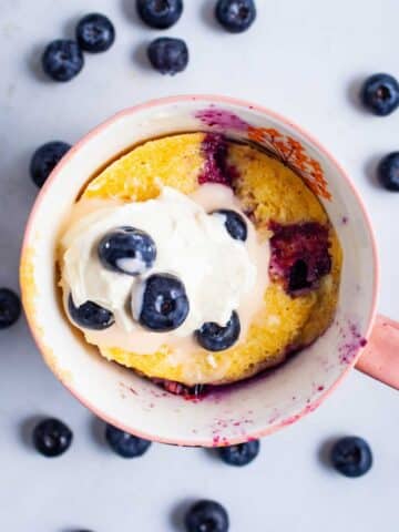 An almond flour mug cake with blueberries.