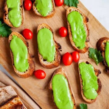 Anchovy starters served on a wooden board.