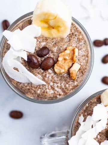 Coffee chia seed pudding in mini cups, topped with walnuts, chopped banana, and coconut flakes.