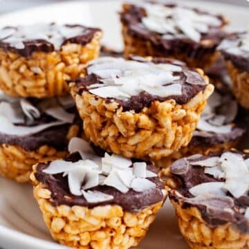 Peanut butter chocolate rice crispy treats stacked on a plate.