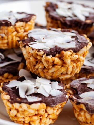 Peanut butter chocolate rice crispy treats stacked on a plate.