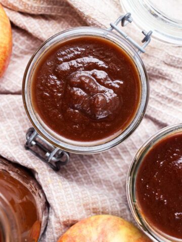 Apple butter stored in glass jars.