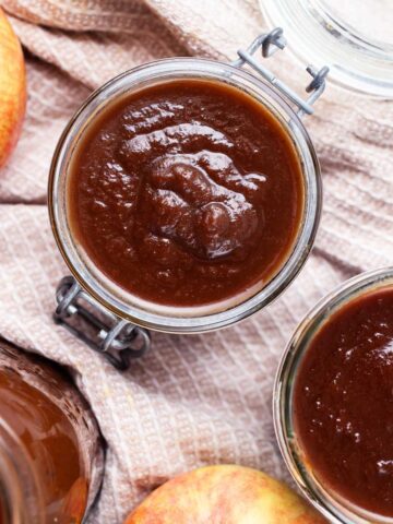 Apple butter stored in glass jars.