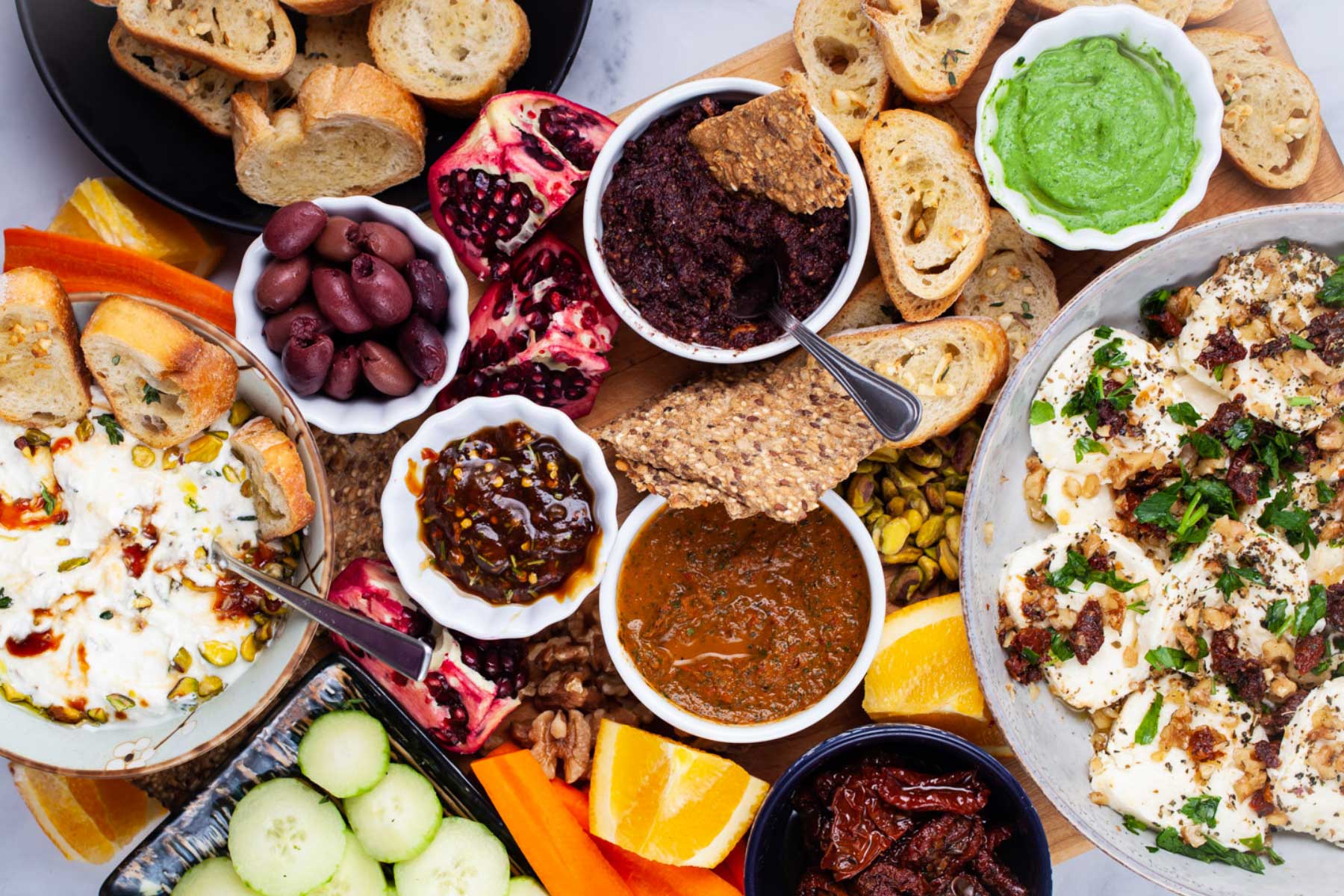 An assortment of Mediterranean plates on a grazing board.