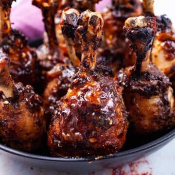 Oven baked lollipop drumsticks on a serving plate.