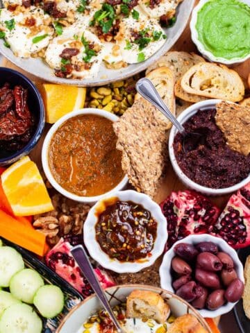 An assortment of Mediterranean plates on a grazing board.