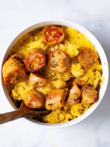 Mashed plantains topped with chicken sausages.