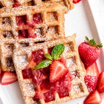 Strawberry waffles on a plate.