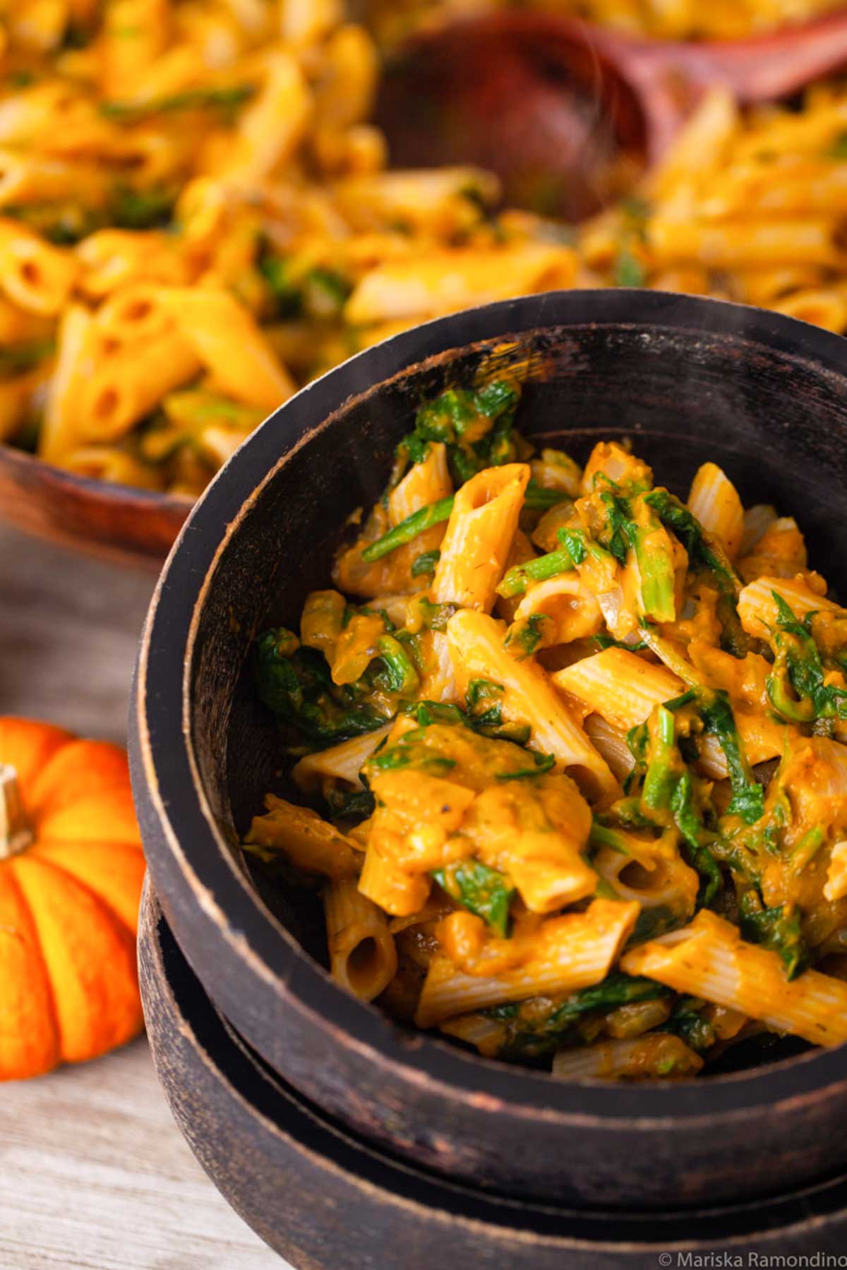 Gluten-free pasta in a vegan pumpkin pasta sauce served in bowls.