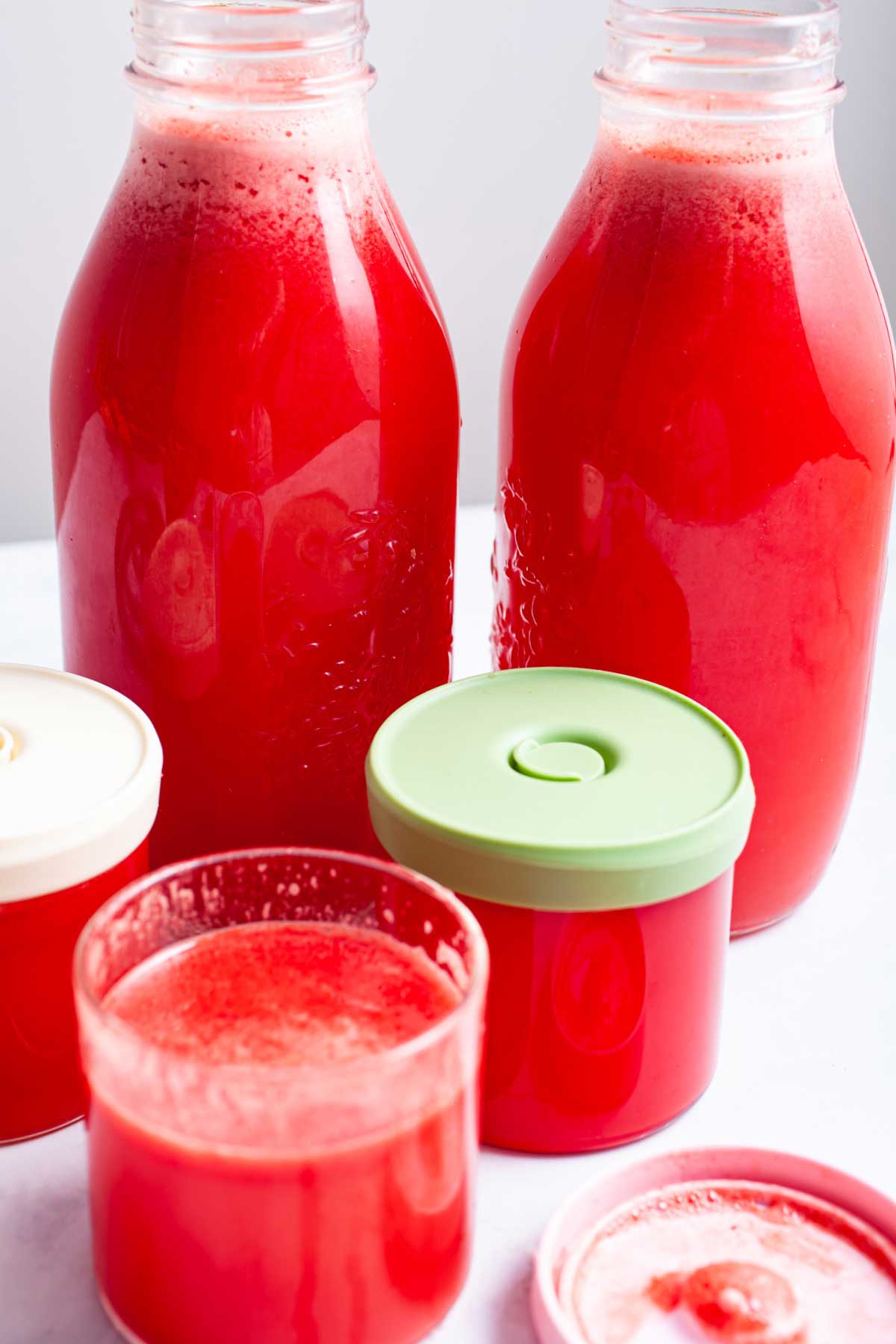 Watermelon and ginger juice in glass bottles.