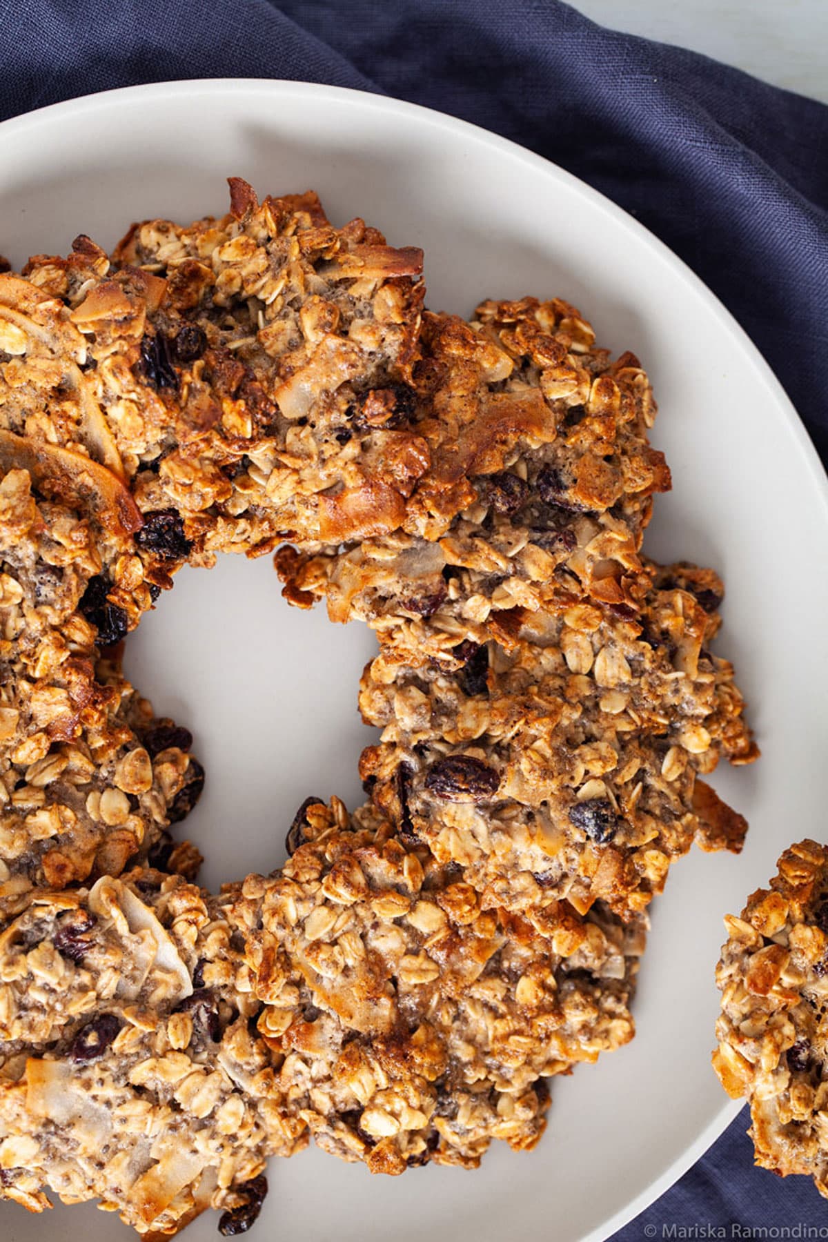 Eggless and vegan oatmeal cookies arranged on a plate.