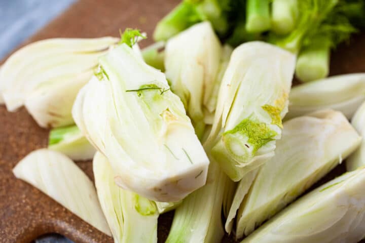 Fresh cut fennel pieces laying on a cutting board.