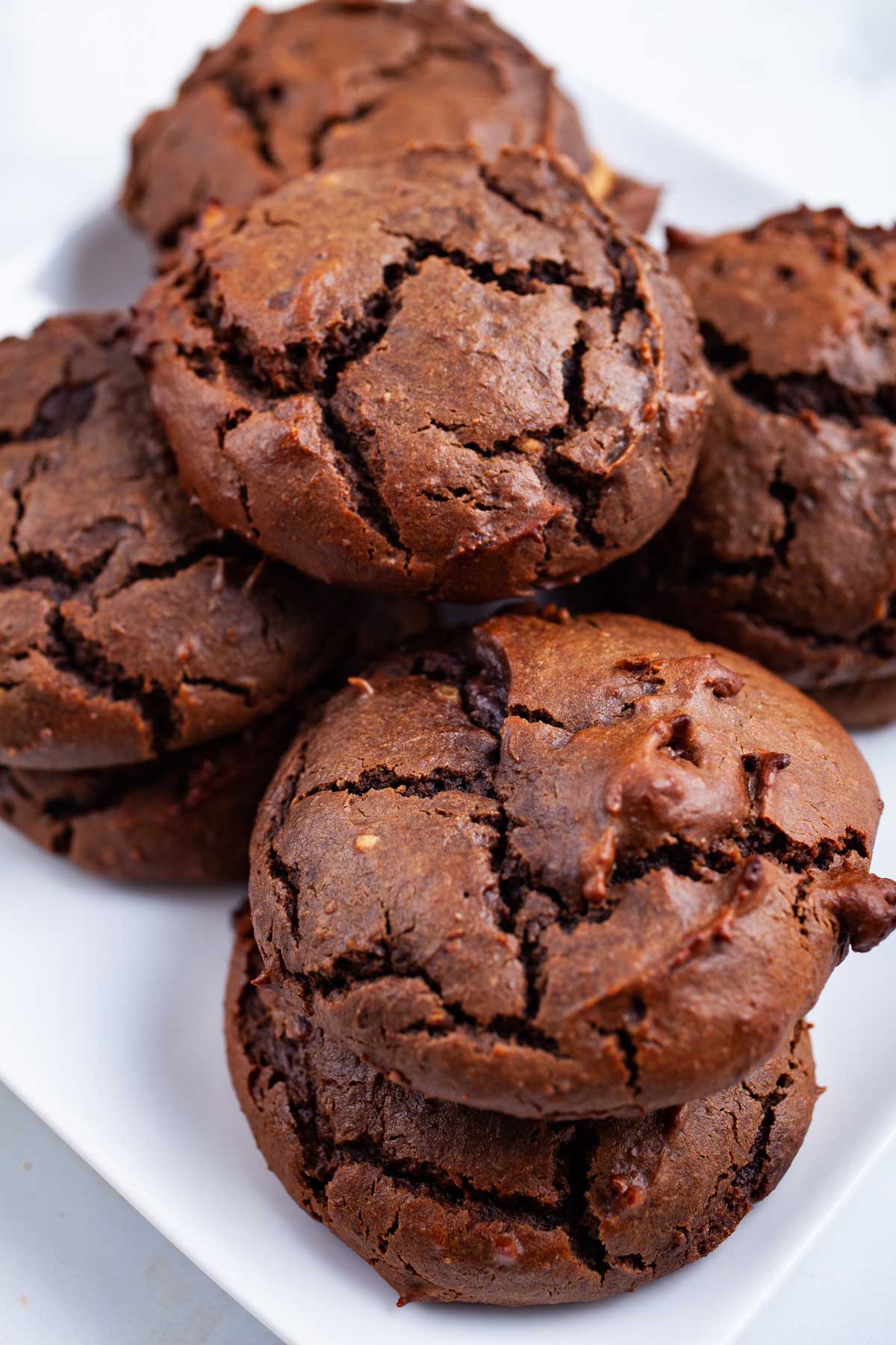Brownie Peanut Butter Cookies stacked on a plate.