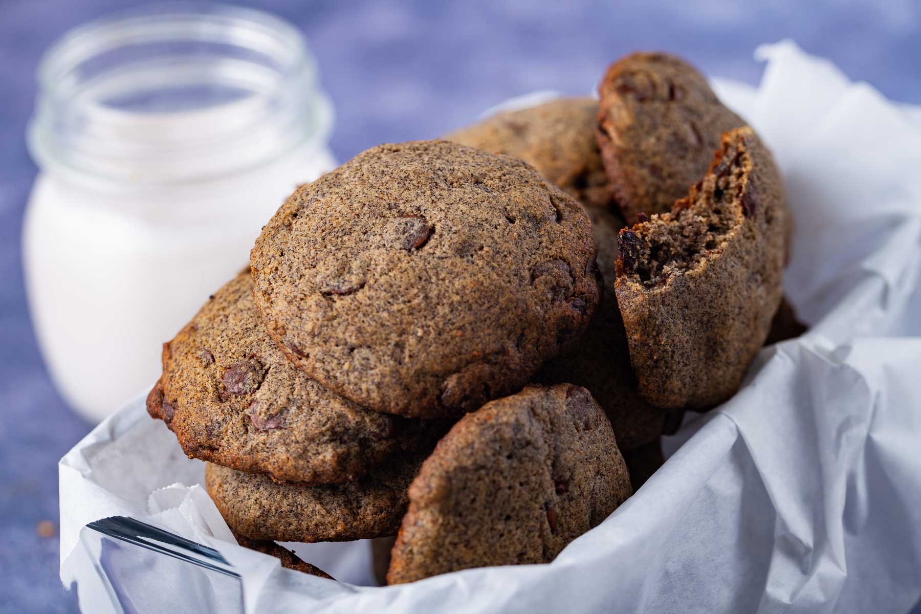 A basket filled with chocolate chip cookies made with buckwheat flour.