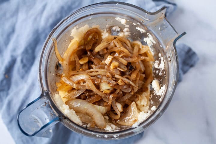 Sauteed onions and garlic on top of pureed cauliflower in a Vitamix blender.