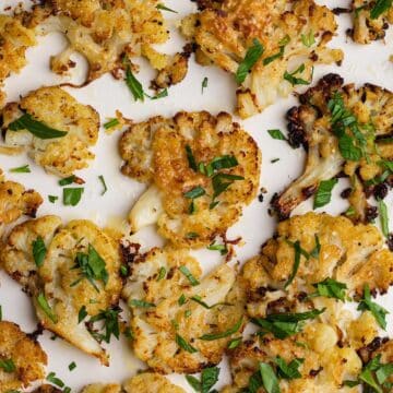 Smashed cauliflower baked until crispy on a large baking sheet.