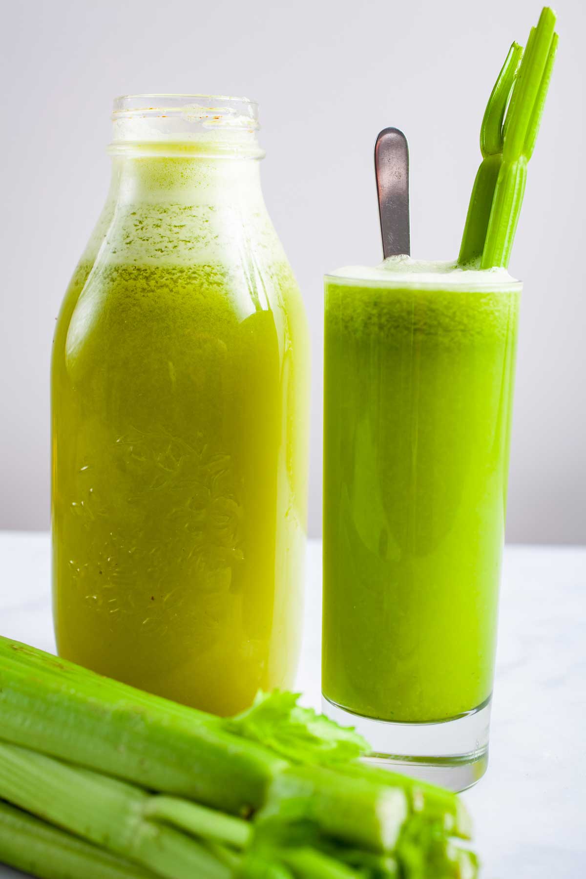 Celery pineapple juice served in a tall glass.