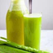 Celery pineapple juice served in a tall glass.