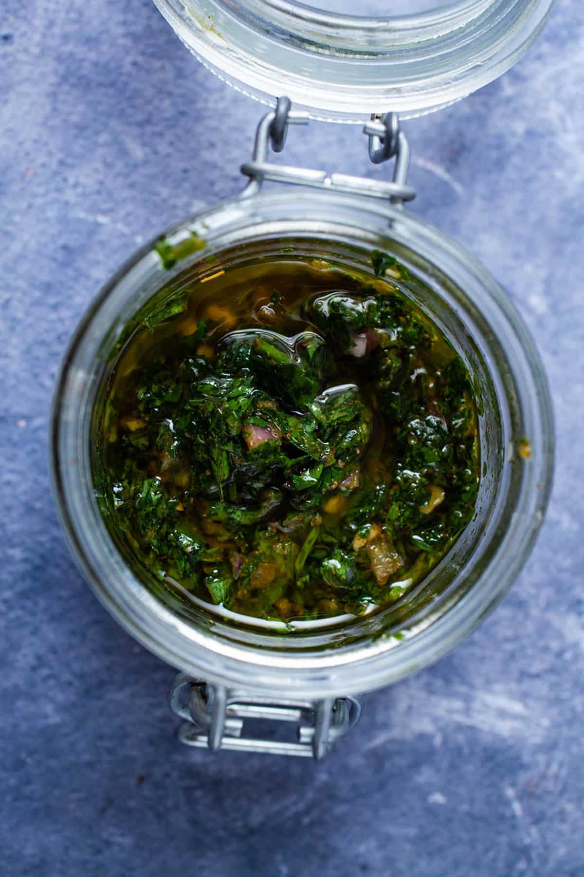 Cilantro parsley chimichurri sauce in a glass container.