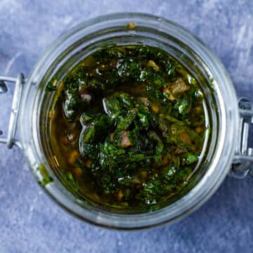 Cilantro parsley chimichurri sauce in a glass container.