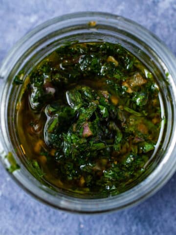 Cilantro parsley chimichurri sauce in a glass container.