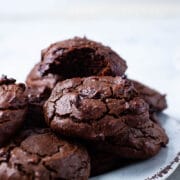 Soft brown chocolatey peanut butter cookies stacked on a small plate.