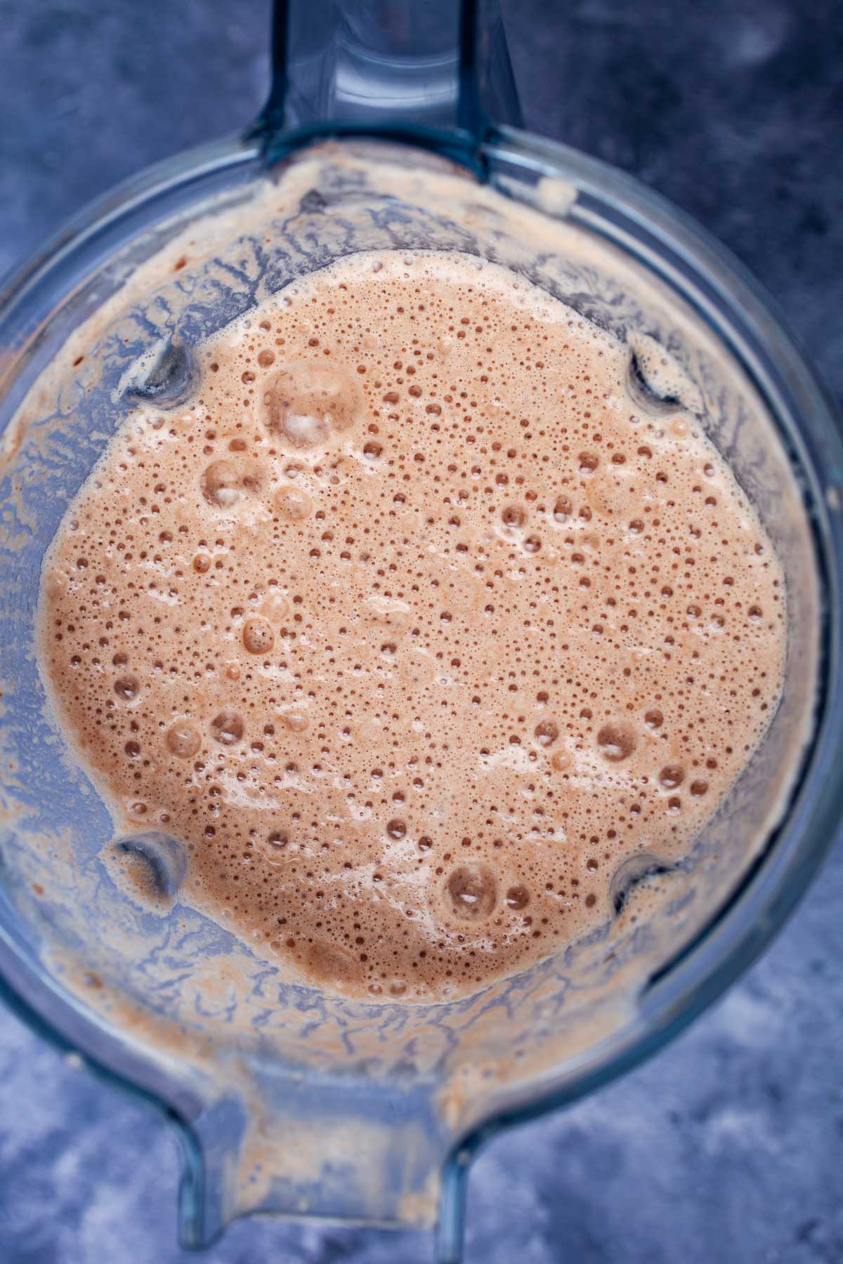 A frothy and chocolaty smoothie in a blender.