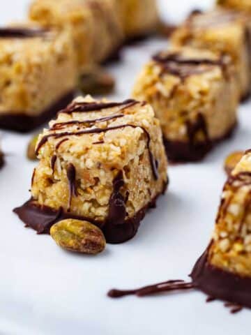 Chocolate covered coconut bites on a plate.