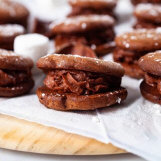 A close-up of a chocolate mascarpone filled sandwich cookie.