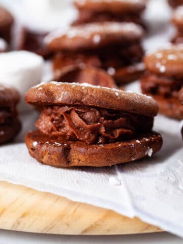 A close-up of a chocolate mascarpone filled sandwich cookie.