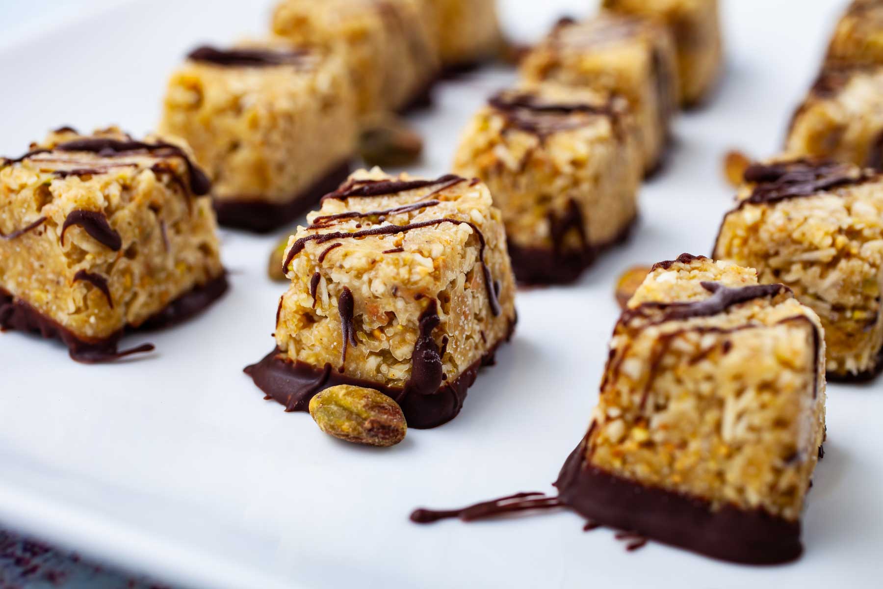 Chocolate covered coconut bites on a plate.