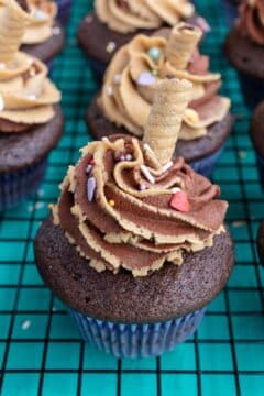 Coffee muffins topped with a sprinkled coffee-infused butter and decorated with a cookie.