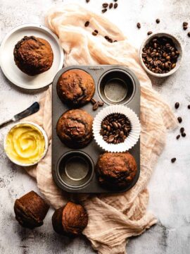 Coffee muffins in a tin muffin decorated with coffee beans.