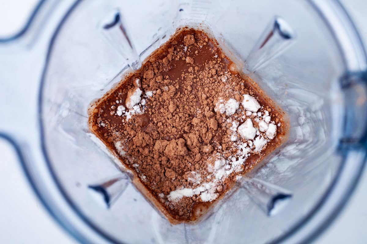 Coffee, cacao powder and collagen in a blender.
