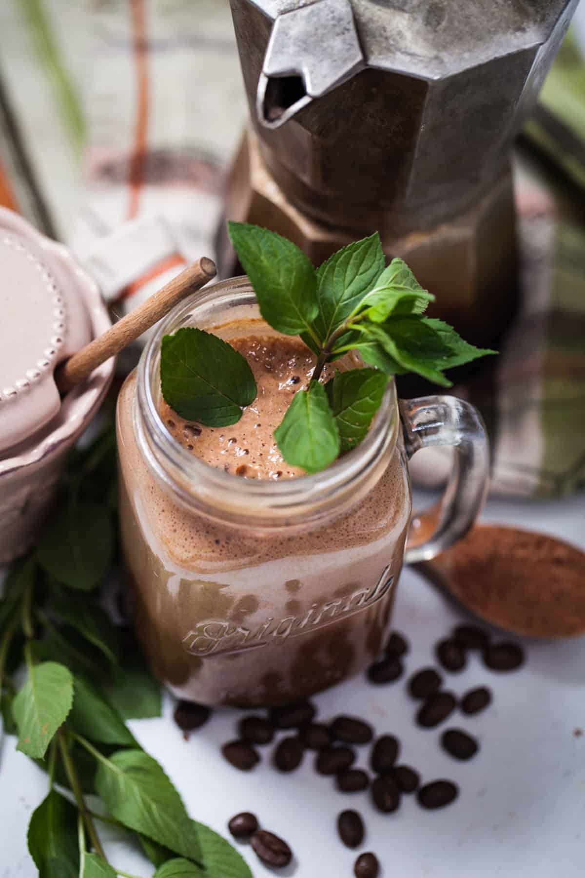 Cold brew coffee smoothie topped with fresh mint leaves.
