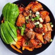 Salmon Bites served with avocado and veggies in a bowl.