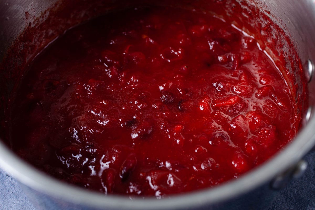 Cooked cranberry sauce in a small pan.