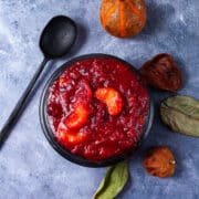 A black bowl containing mandarin orange cranberry sauce.