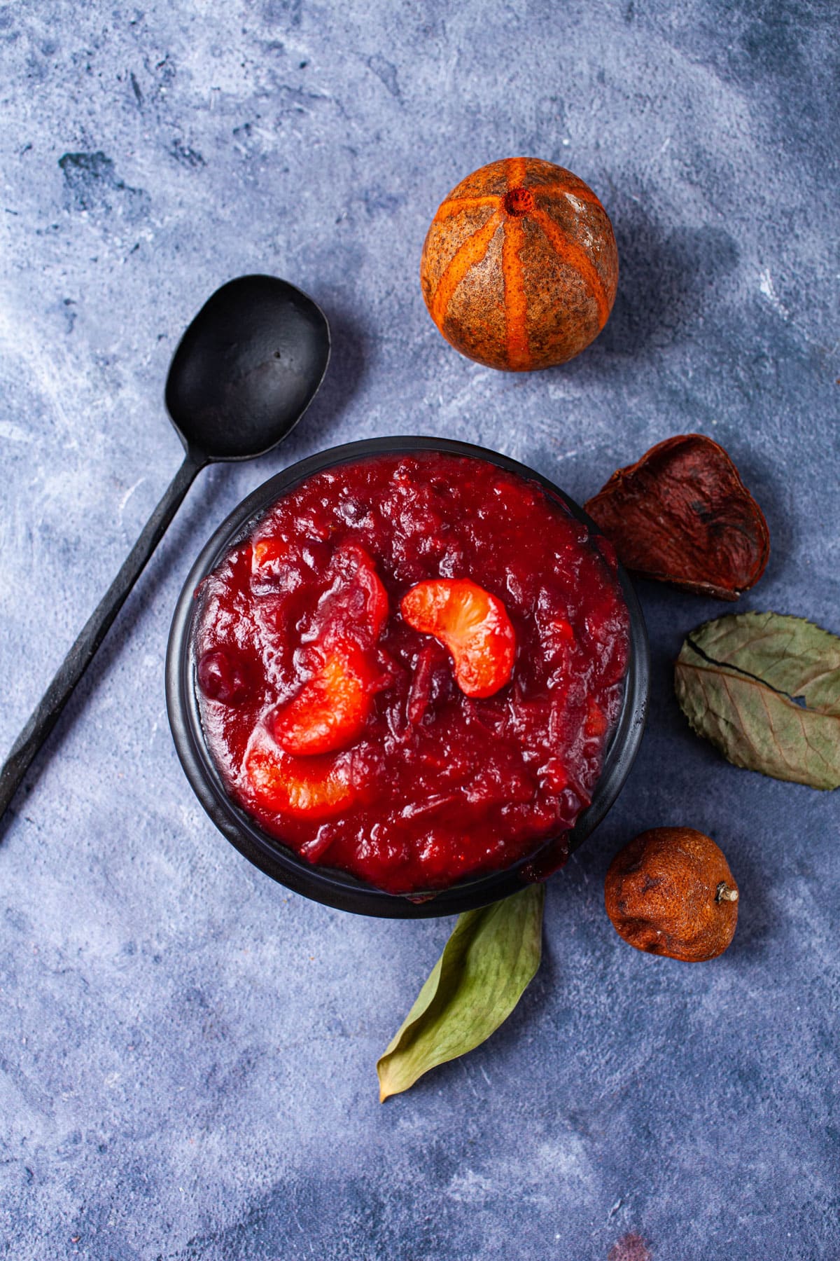 A black bowl containing mandarin orange cranberry sauce.